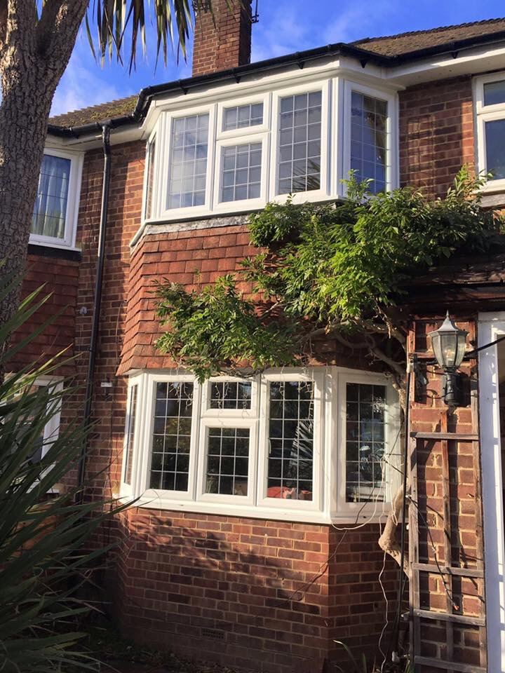 White uPVC bay window, two-storey